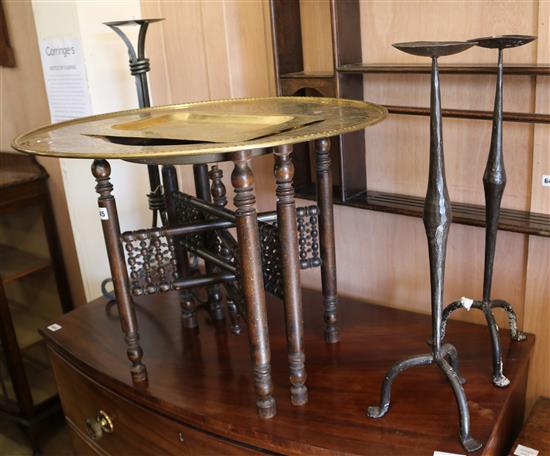 A Benares brass top occasional table, a brass tray and three wrought iron pricket candlesticks, table diameter 66cm
